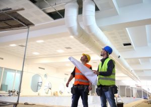 HVAC-technicians-working-on-a-commercial-system
